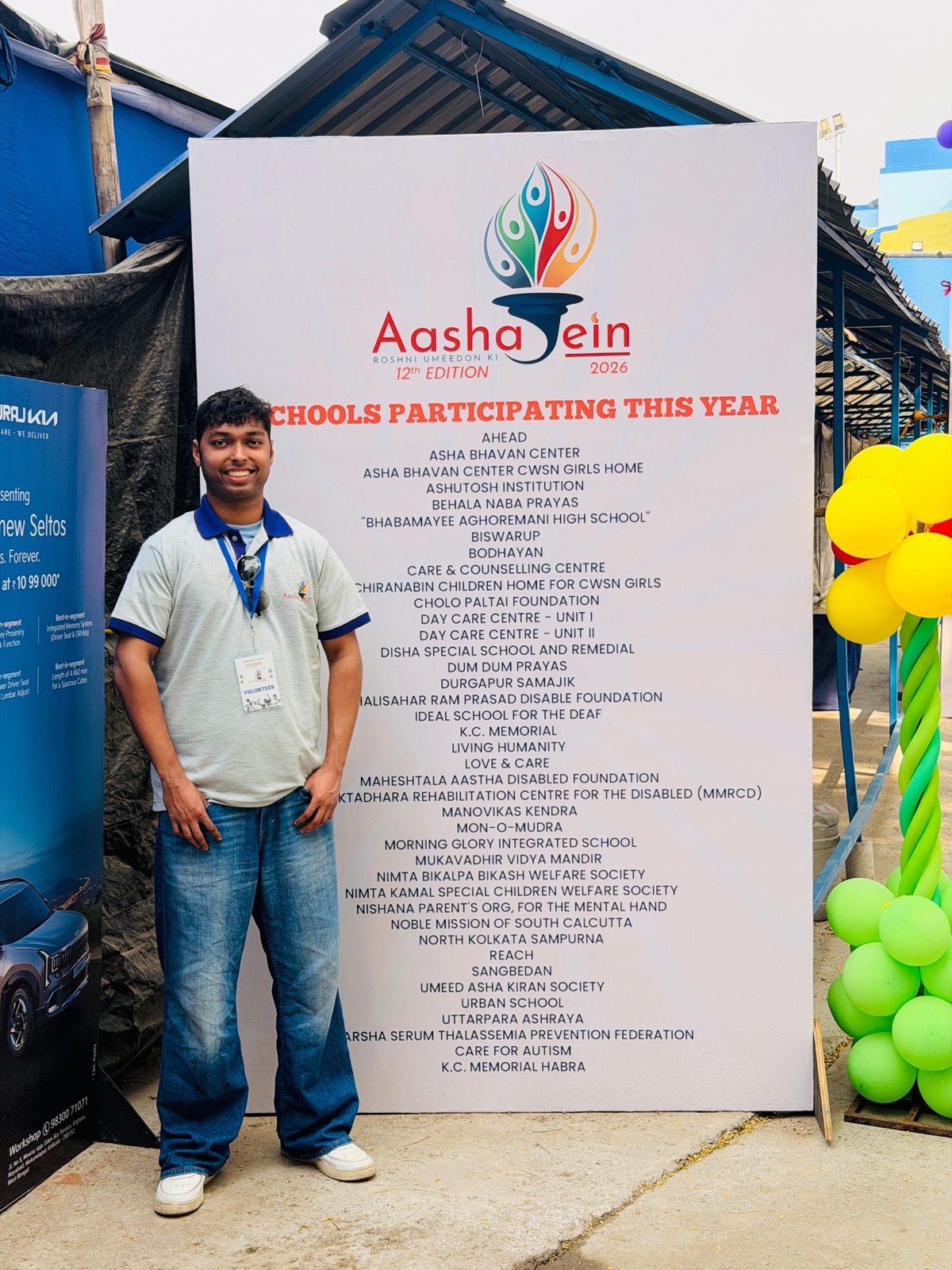 Me beside the board of participating schools at Aashayein 2026